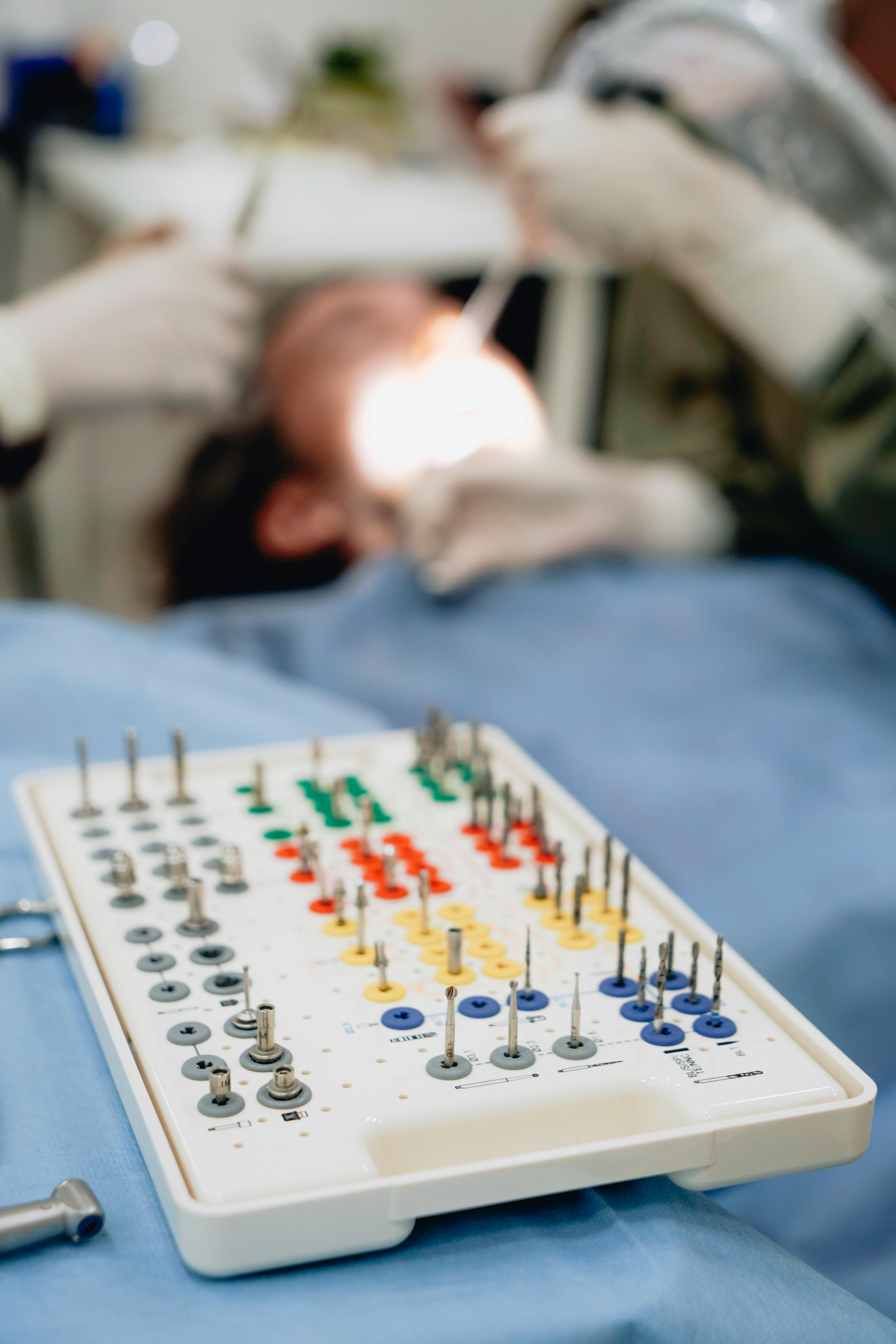 Photo Of Dental Implant Tools Tray With Patient Undergoing Procedure In Background Representing All On 4 Success Rate In Clinical Setting