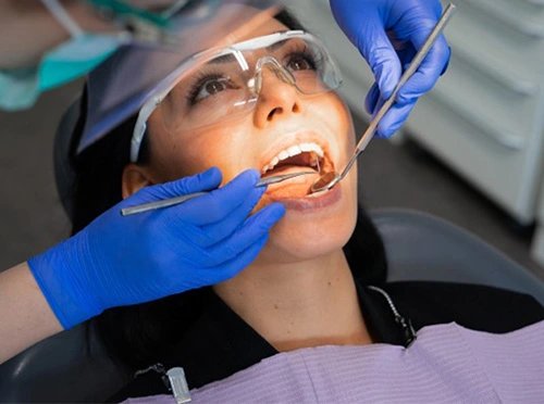 Photo Of A Dentist Performing An Oral Exam On A Patient To Ensure Are Dental Implants Safe