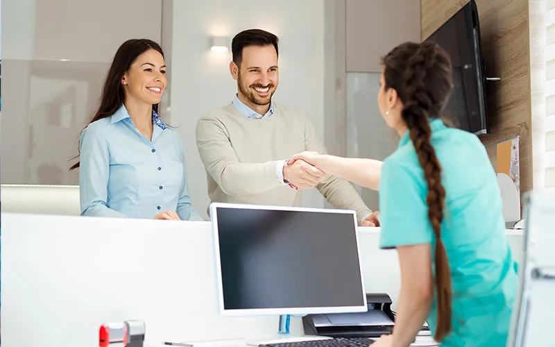 Photo Of Patients Shaking Hands After Dental Implant Consultation